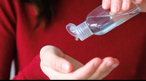 A woman using hand sanitiser 