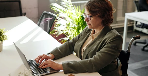 Woman working on a laptop in an office