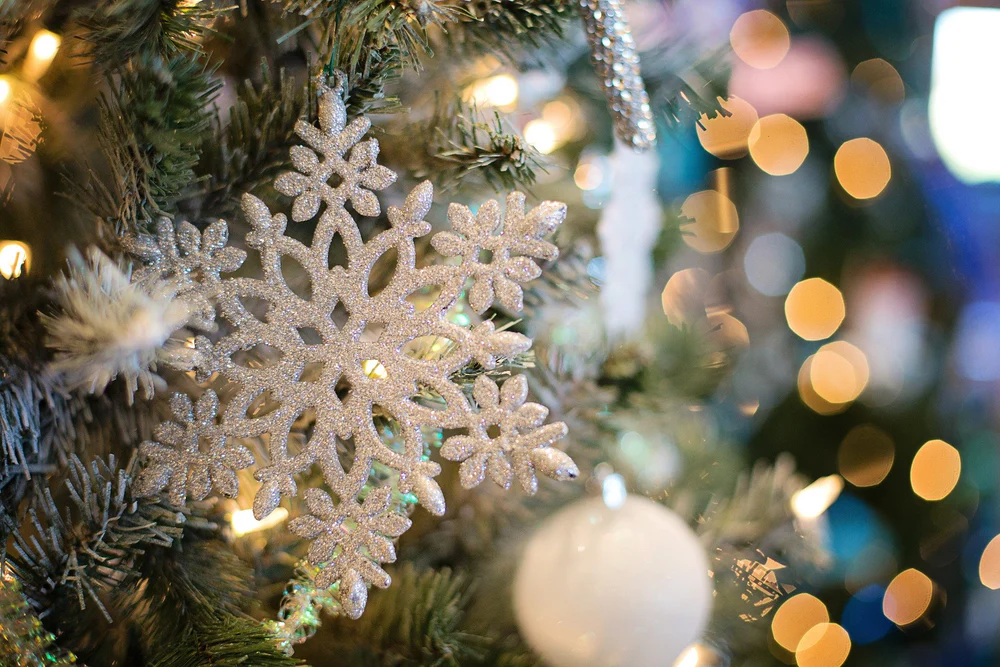 A snowflake ornament on a Christmas tree